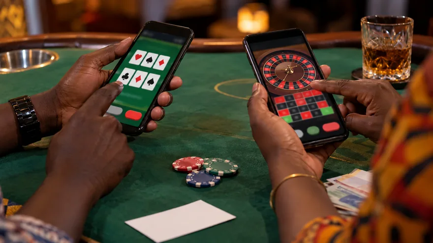 Best online casino comparison in Zambia with separate card and roulette screens on two phones beside plain gaming objects.