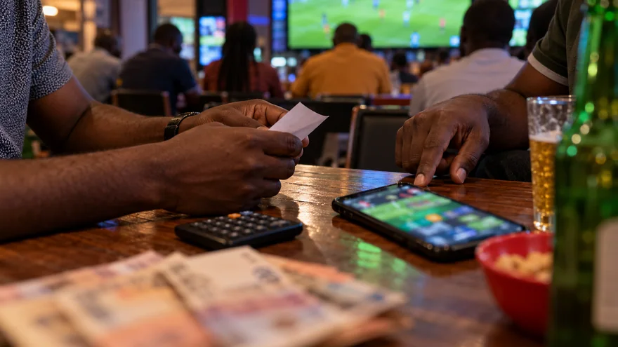 betPawa bonus illustrated by a coupon calculation beside a sports betting phone.