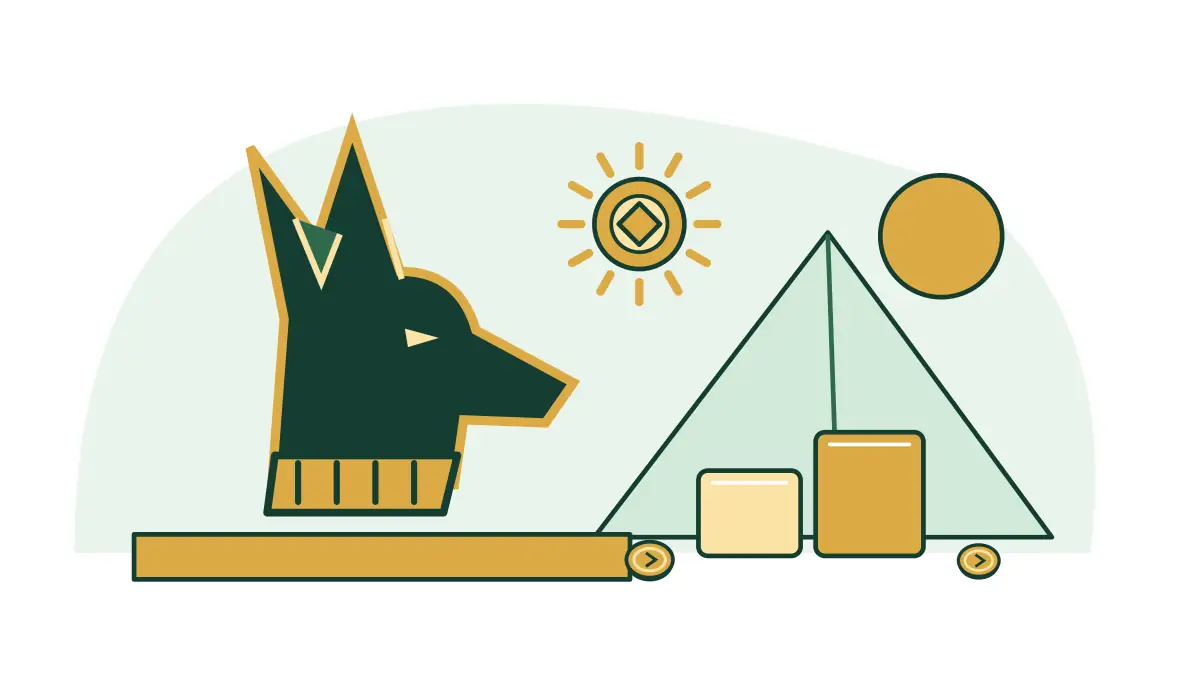 A jackal-headed amulet stands beside Egyptian blocks and gold medallions.